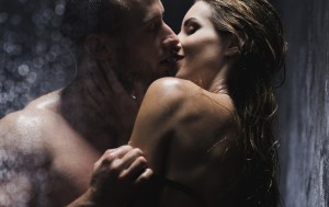 A man and woman seductively embracing each other and kissing whilst naked.